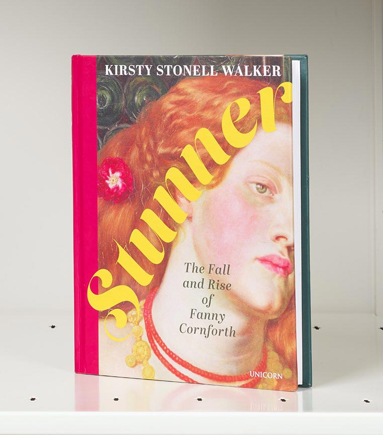 Book cover on a white shelf featuring a closeup of a woman's face with red hair