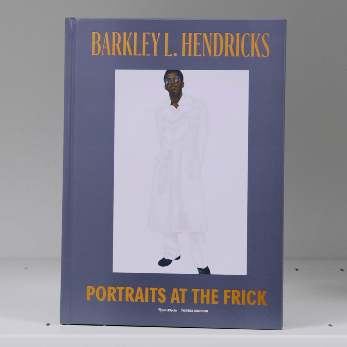 Book cover featuring a full-length portrait of a man in sunglasses, a long white jacket, and white pants against a white background