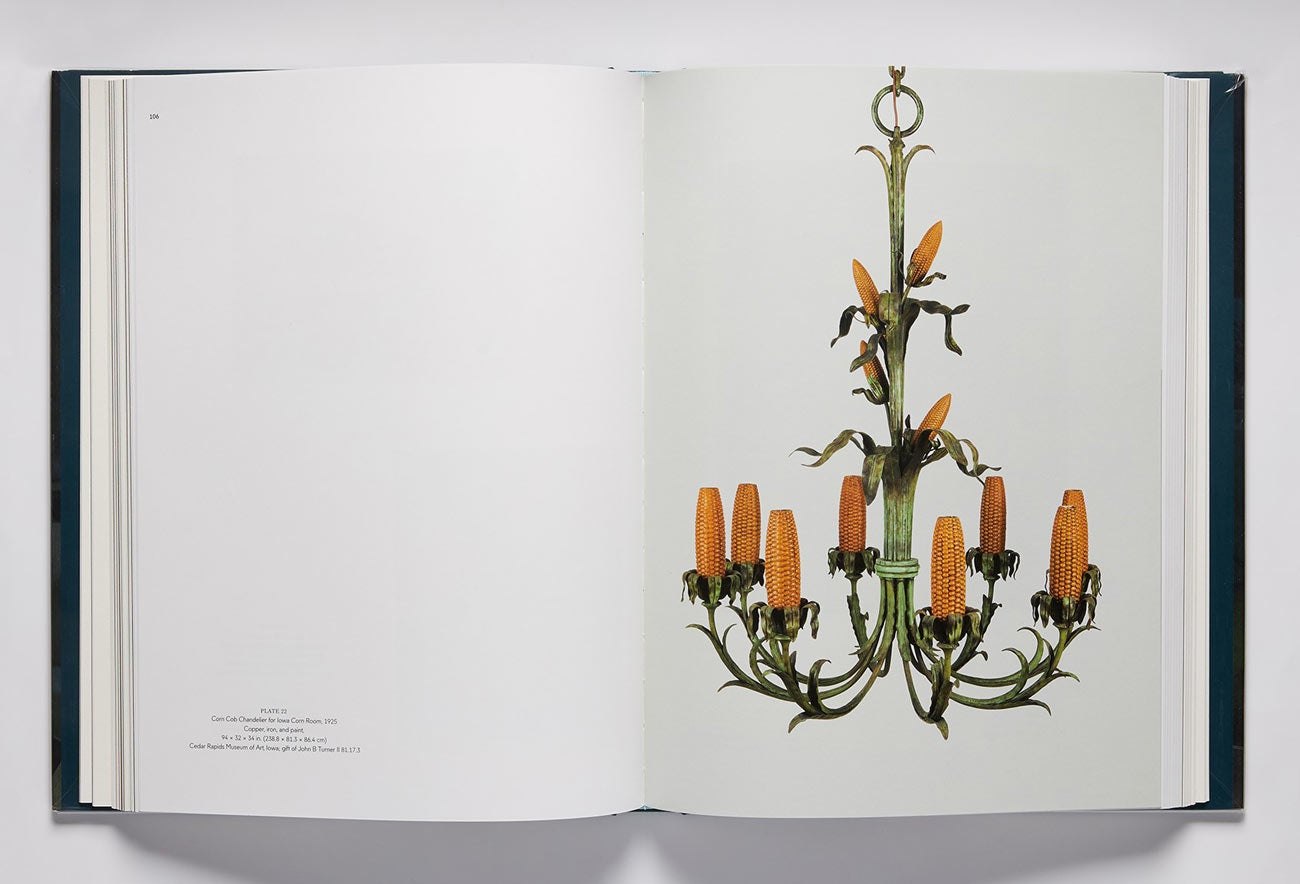 Book spread featuring an image of a chandelier made out of fake corncobs