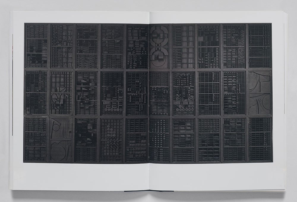 Book spread featuring an intricate black sculpture divided into 30 rectangles