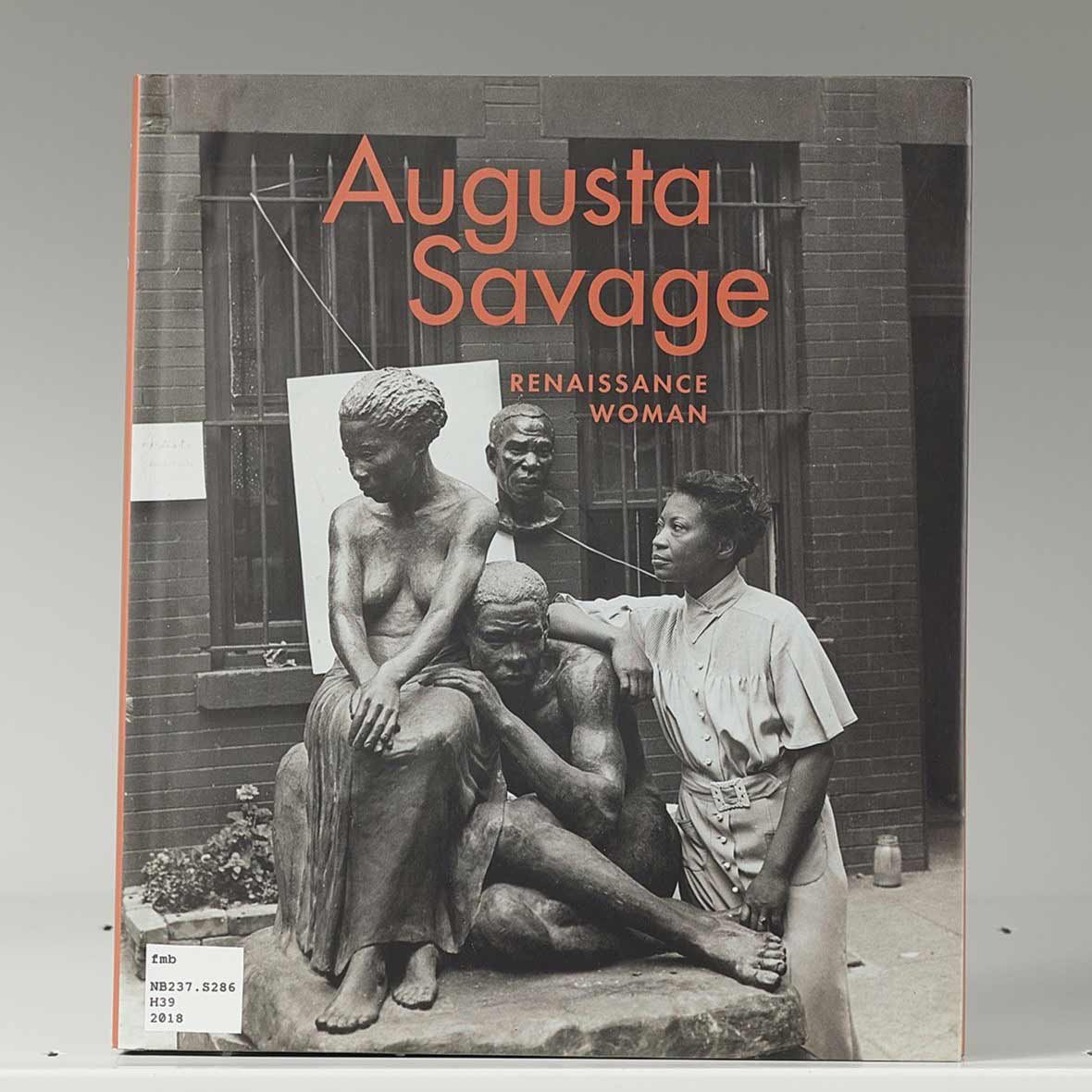 Book cover on a white shelf featuring a sculptor with a large statue of two figures