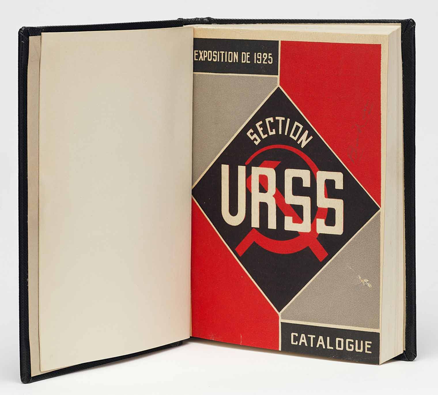 Book open to a cover page reading "Exposition de 1925, Section URSS, Catalogue" in front of a Soviet hammer and sickle