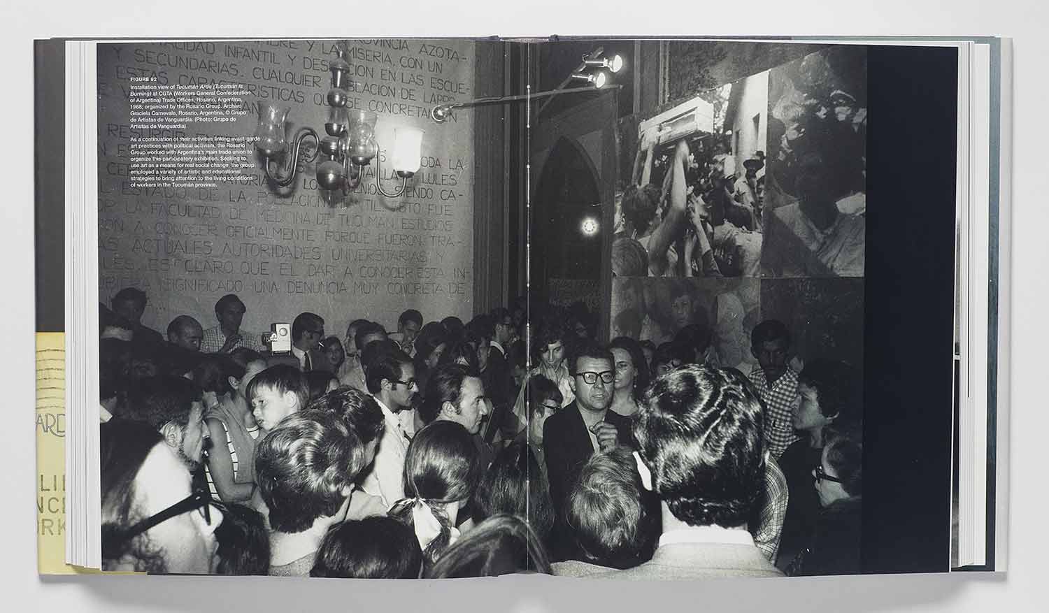 Book spread featuring an image of people crowded into an interior space