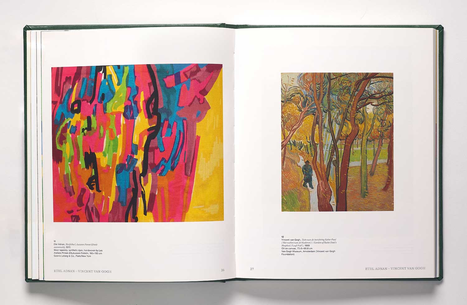 Book spread featuring a colorful abstract painting opposite a colorful landscape with a figure among trees