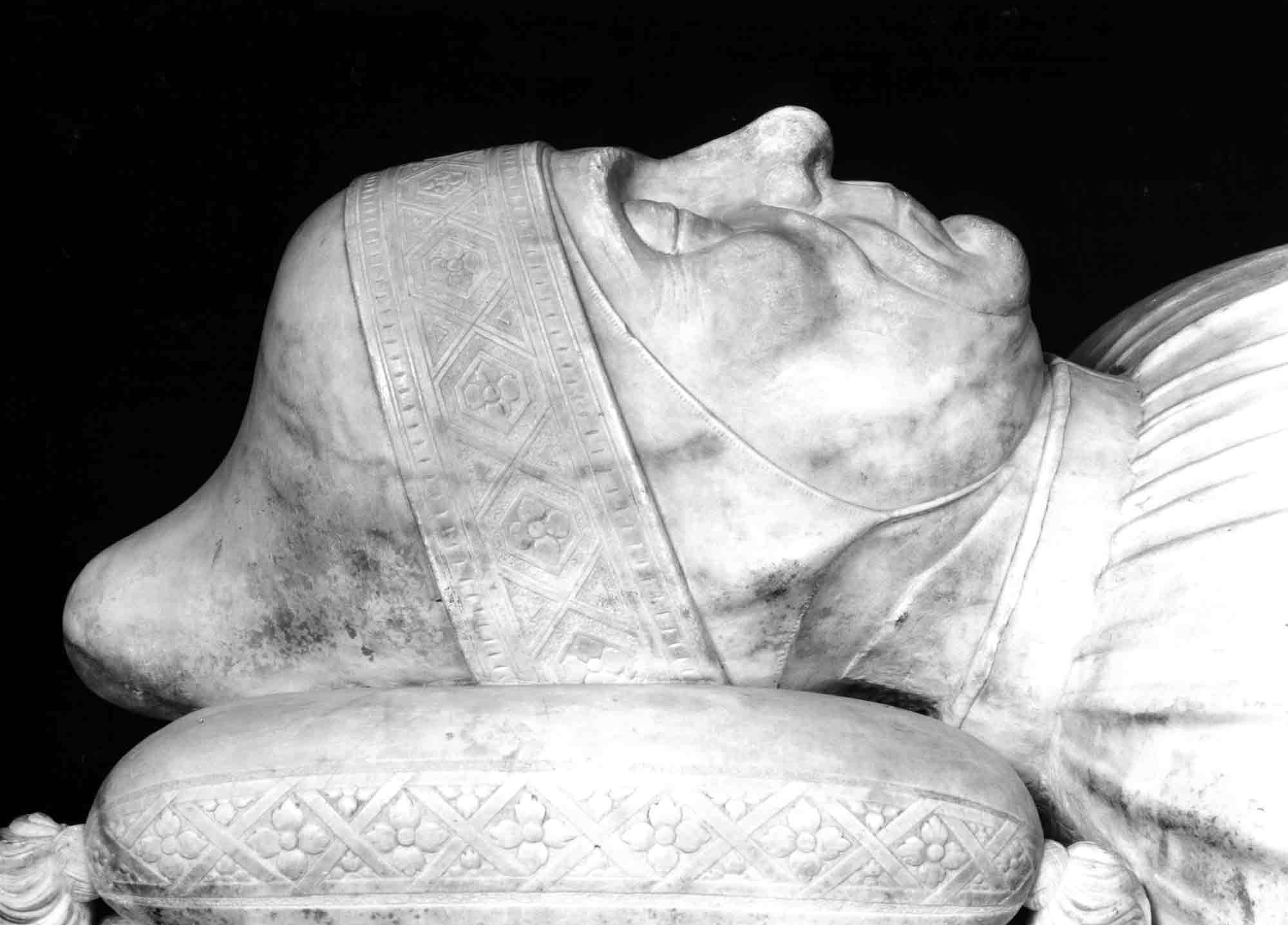 Detail of a photograph of a tomb monument showing a close-up of the effigy's profile.