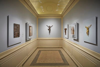 gallery view including crucifixes and bronze sculpture