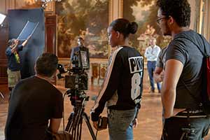 photo of students with equipment filming in gallery