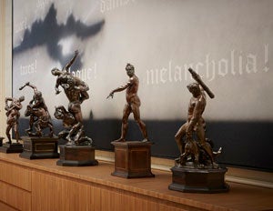 photo of statuettes on wood table 
