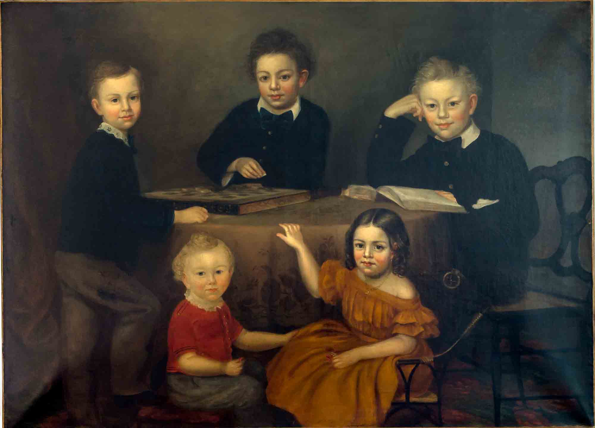 Group portrait of four young brothers and their young sister seated around a table.