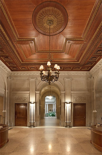 photo of Frick Entrance Hall, including hanging light fixture, and archway, circa 2010