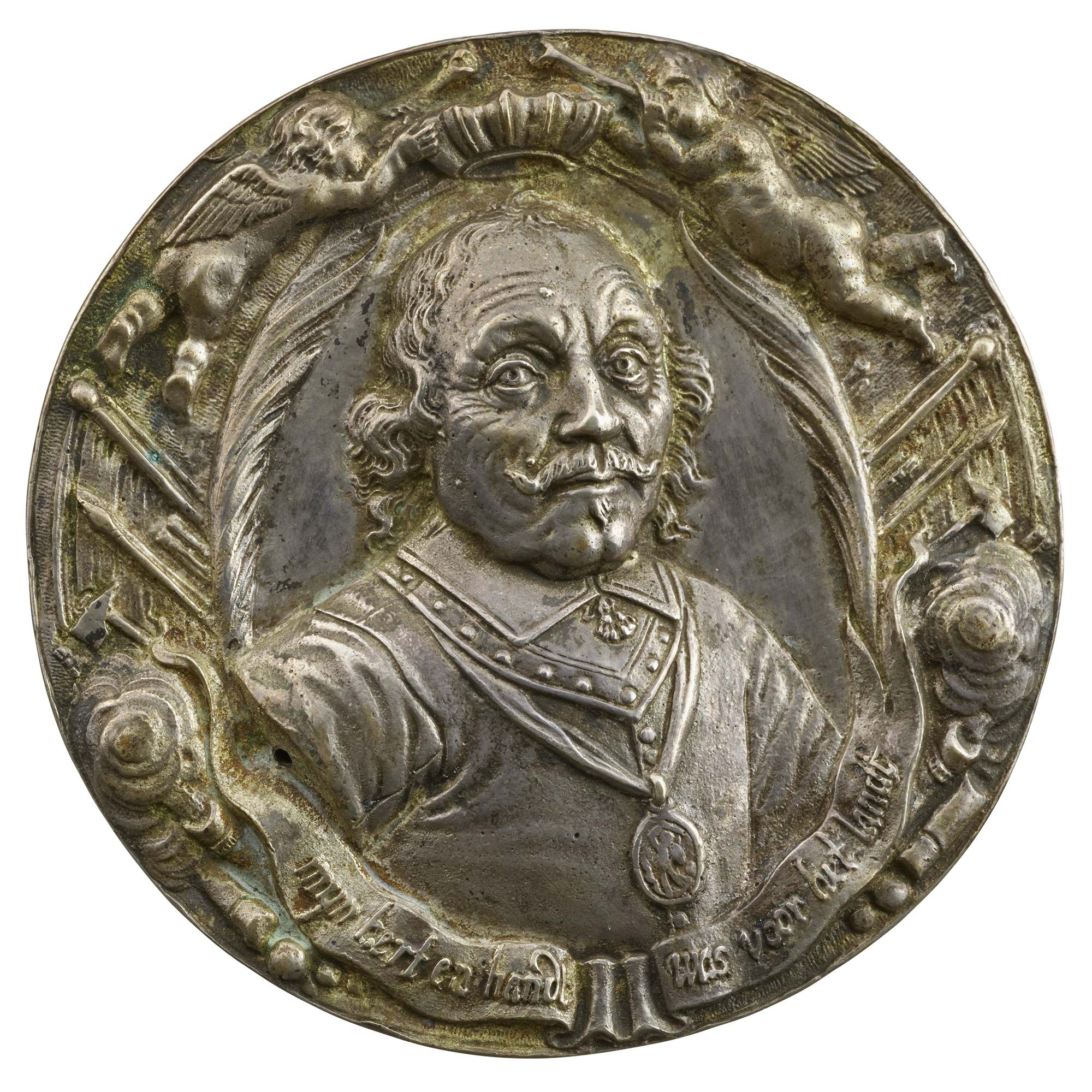 Silver portrait medal of Admiral Maarten Harpertszoon Tromp wearing a plain collar, metal gorget, buttoned doublet, and badge of the Order of St. Michael on a ribbon, flanked by two palm branches, banners, clouds, and cannons. Above, two putti hold a crown over his head formed by the prows of ships