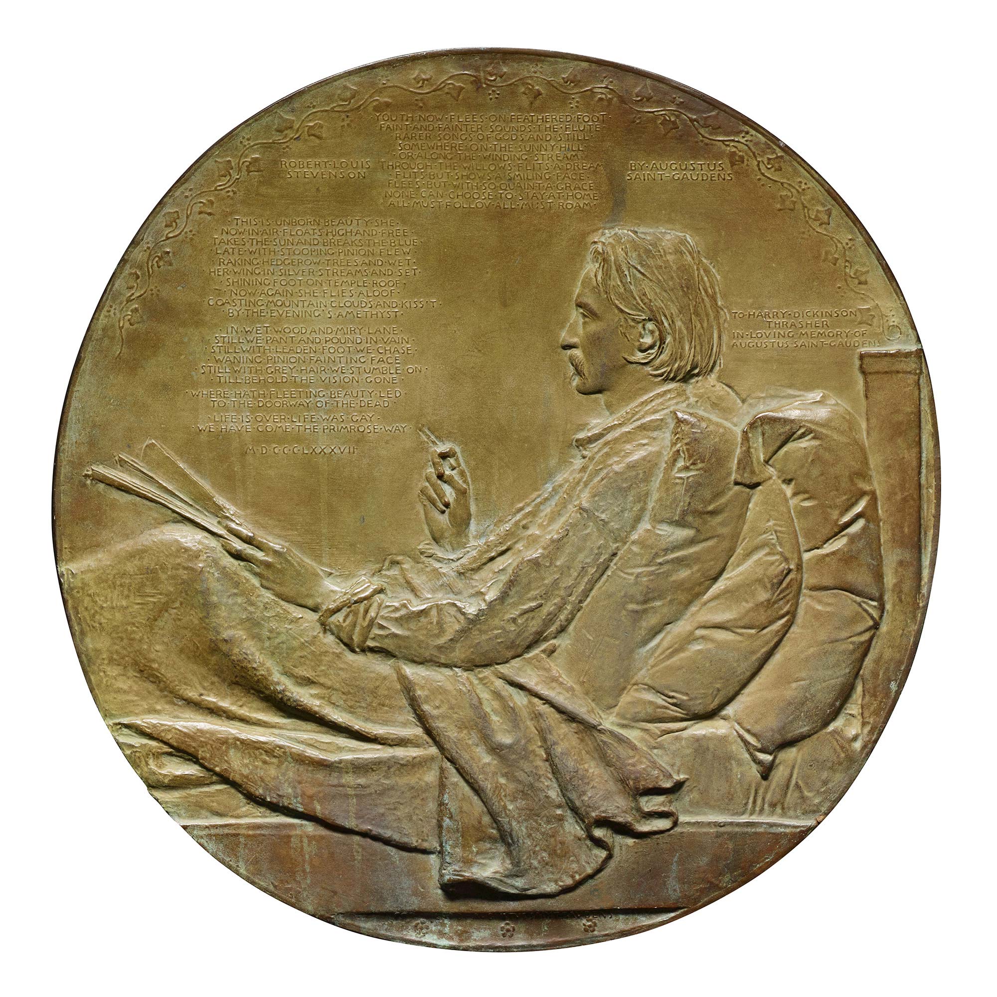 Bronze medal of a man reclining in bed against pillows and with a blanket on his lap, sheets of paper in his left hand and a cigarette in his right