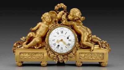 Clock surrounded by gilt-bronze sculptures of flowers, two babies, and doves