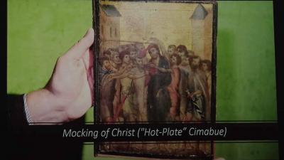 hand holding an artwork of Christ