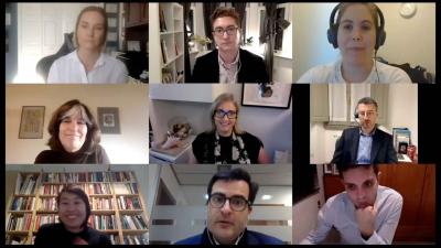video still of nine people conversing on a video call or talk