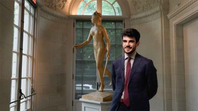 video still of Giulio Dalvit standing in front of sculpture of nude woman in gallery