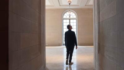 video still of man in stone entryway