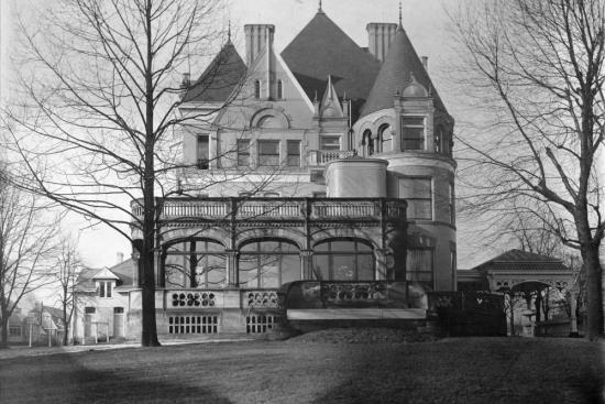 black and white photograph of clayton exterior, a grand mansion with turrets and a sunroom