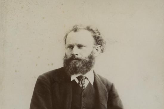 black and white photograph of Edouard Manet seated with hands folded in lap