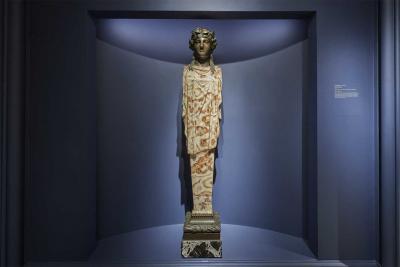 screenshot of virtual tour showing alabaster and glazed bronze sculpture of standing woman, with headdress of vines in gallery 