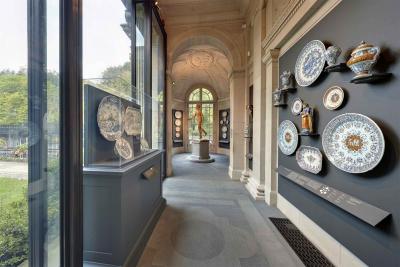 still of plates and porcelain figures in gallery with windows