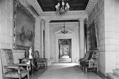 photo of hallway with chairs, paintings, chandeliers, columns, circa 1927