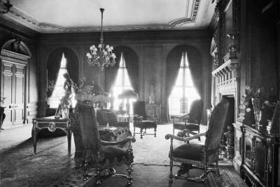 photo of room with chairs, chandelier, windows, fireplace, circa 1927