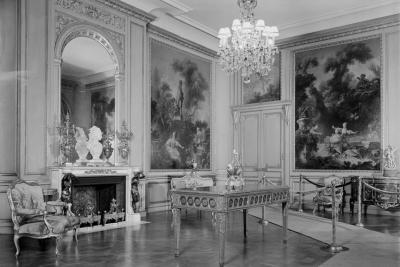 photo of gallery with paintings in panels, chandelier, table, ropes, runner, circa 1935