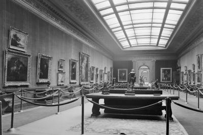 photo of gallery with paintings with barrier roping and skylight, circa 1935