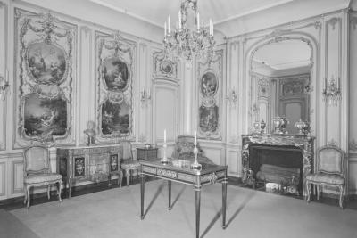photo of gallery room's northeast corner, including paintings, chandelier, fireplace, tables, circa 1953