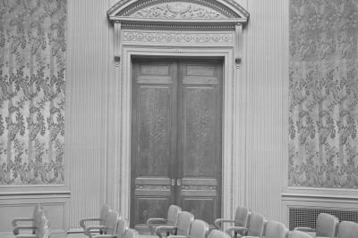 photo of room with empty seats and door, circa 1963