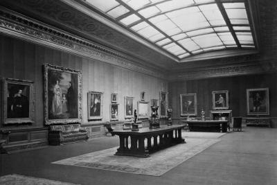 photo of gallery with paintings, sculptures on tables, skylight, circa 1927