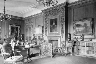 photo of library room with short bookcases, paintings, chairs, chandeliers, circa 1927