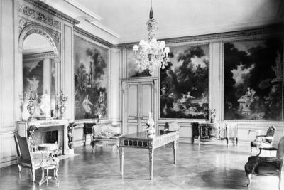 photo of room with paintings in panels, chandelier, table, chairs, circa 1927