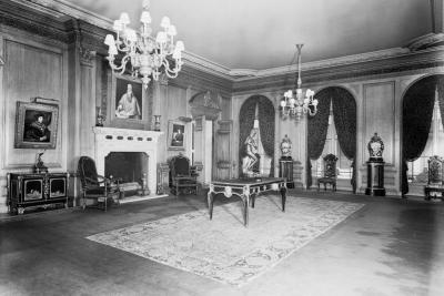 photo of gallery room with chairs, chandeliers, tables, sculptures, paintings circa 1938