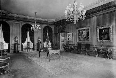 photo of room with chairs, chandeliers, tables, sculptures, paintings circa 1938