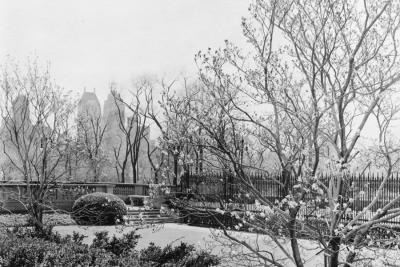 photo of gated garden with buildings in background, circa 1939