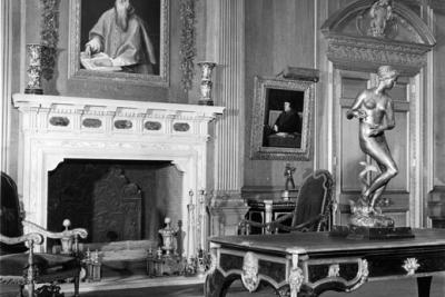 photo of room with paintings, fireplace, sculpture on table, circa 1940