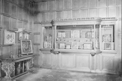 photo of glass case with paintings and paintings and table, circa 1942