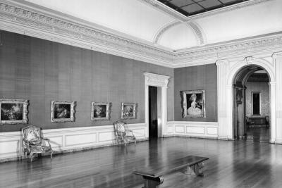 photo of gallery with paintings, chair, bench and doorways, circa 1942