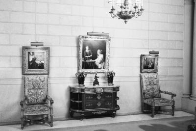 photo of hallway with paintings, chairs, tables, sculptures and chandelier, circa 1937 