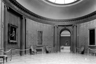 photo of oval shaped gallery room with paintings, rope, and doorway, skylight, circa 1935