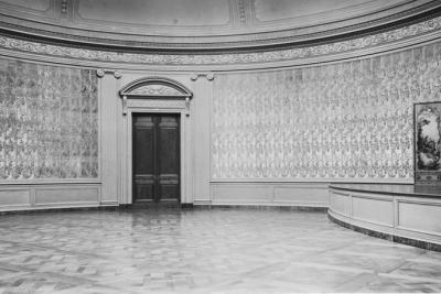 photo of circular room with paintings and stage, circa 1935