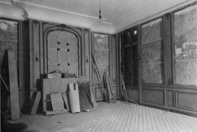 photo of stripped room with constuction materials, circa 1935