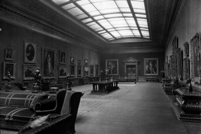 photos of gallery with paintings, seating, sculpture on tables, and skylight, circa 1927