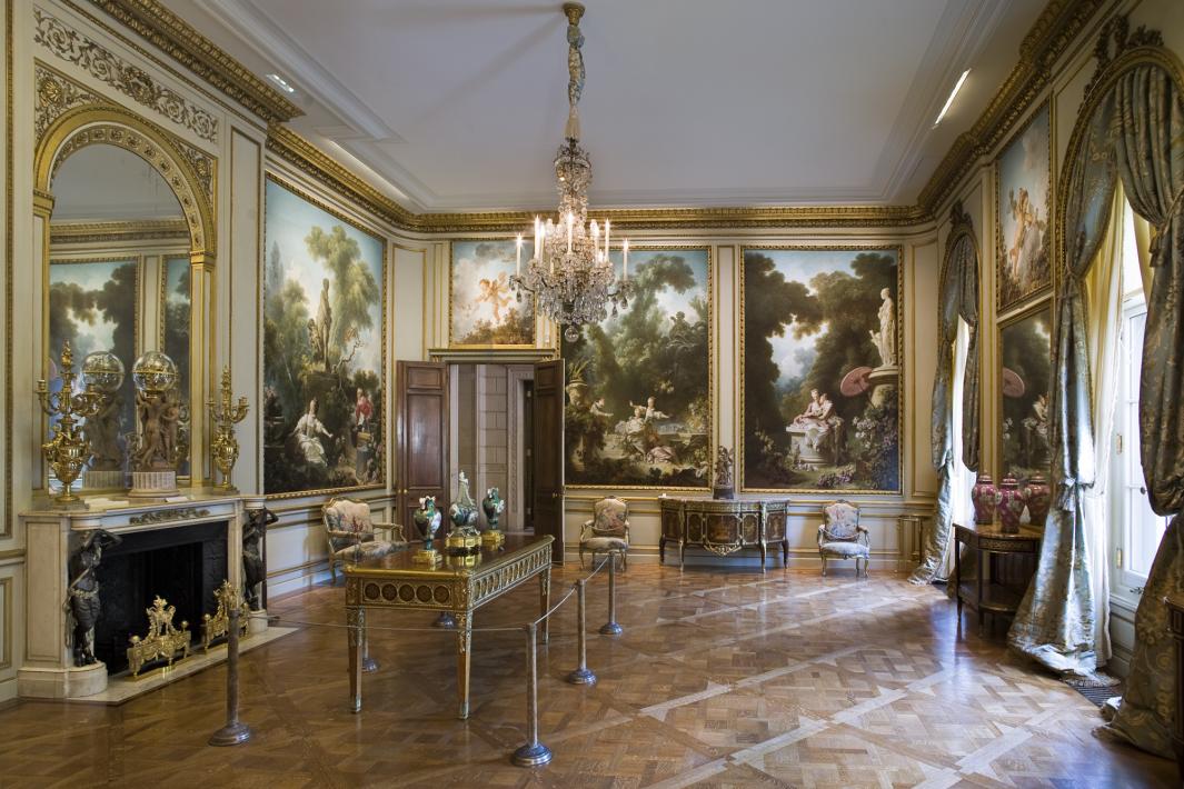 The Fragonard Room of The Frick Collection with Fragonard paintings lining the walls
