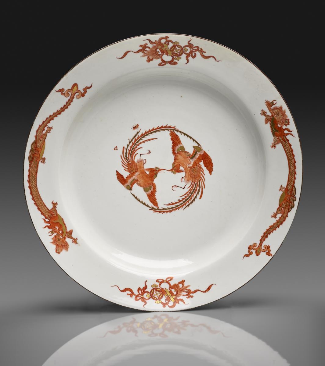 photo of white porcelain dish decorated with red dragons