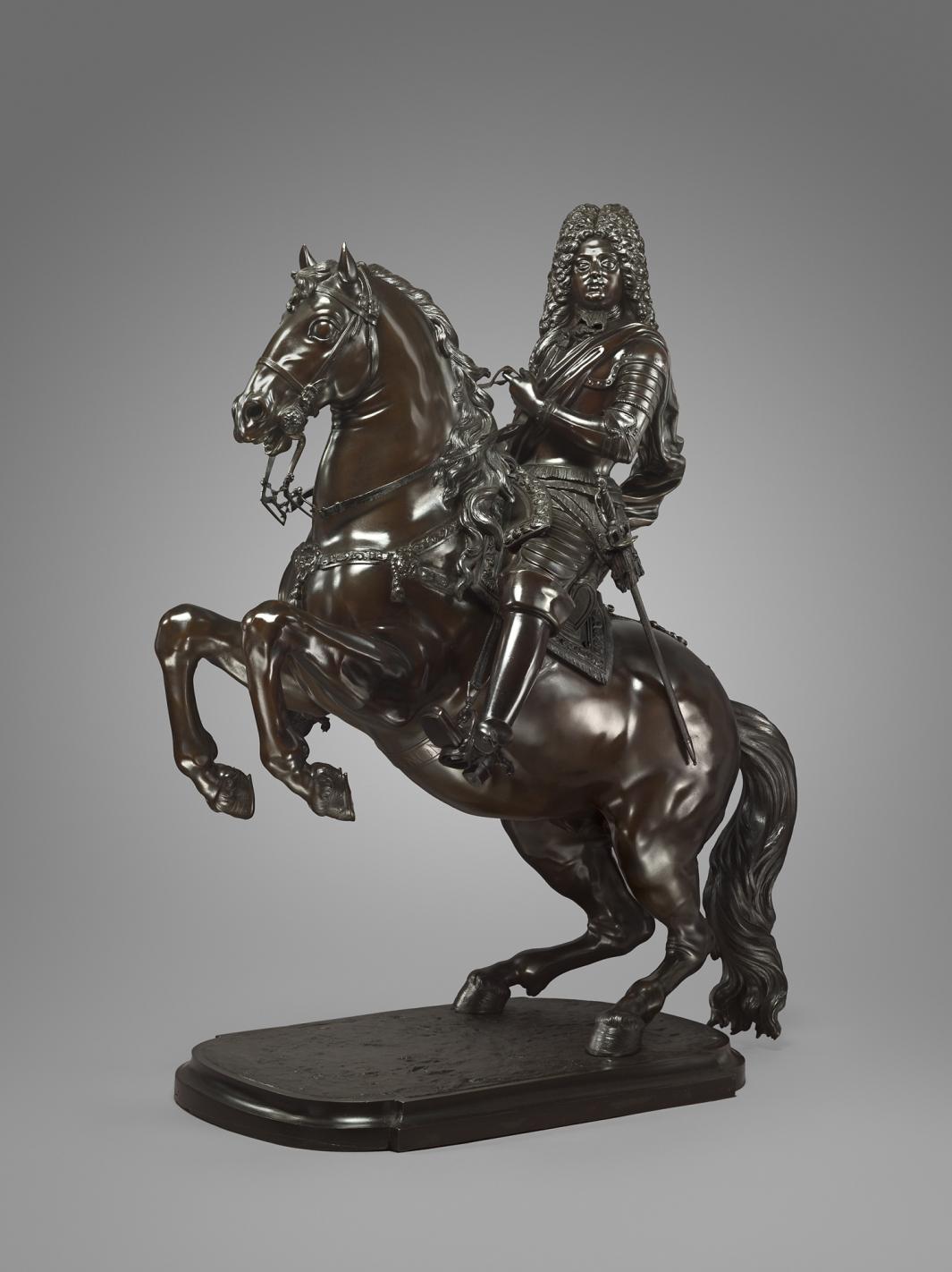 Bronze sculpture of a man on a rearing horse.