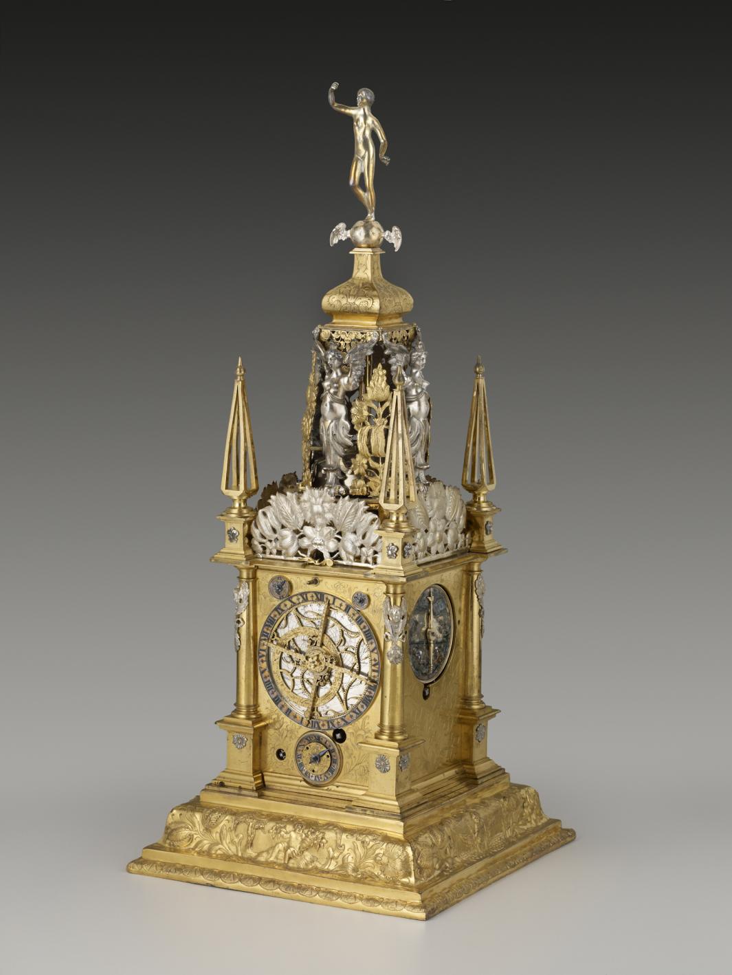 gilt-brass and silver table clock in the shape of a tower, with multiple dials, including astronomical and calendrical dials