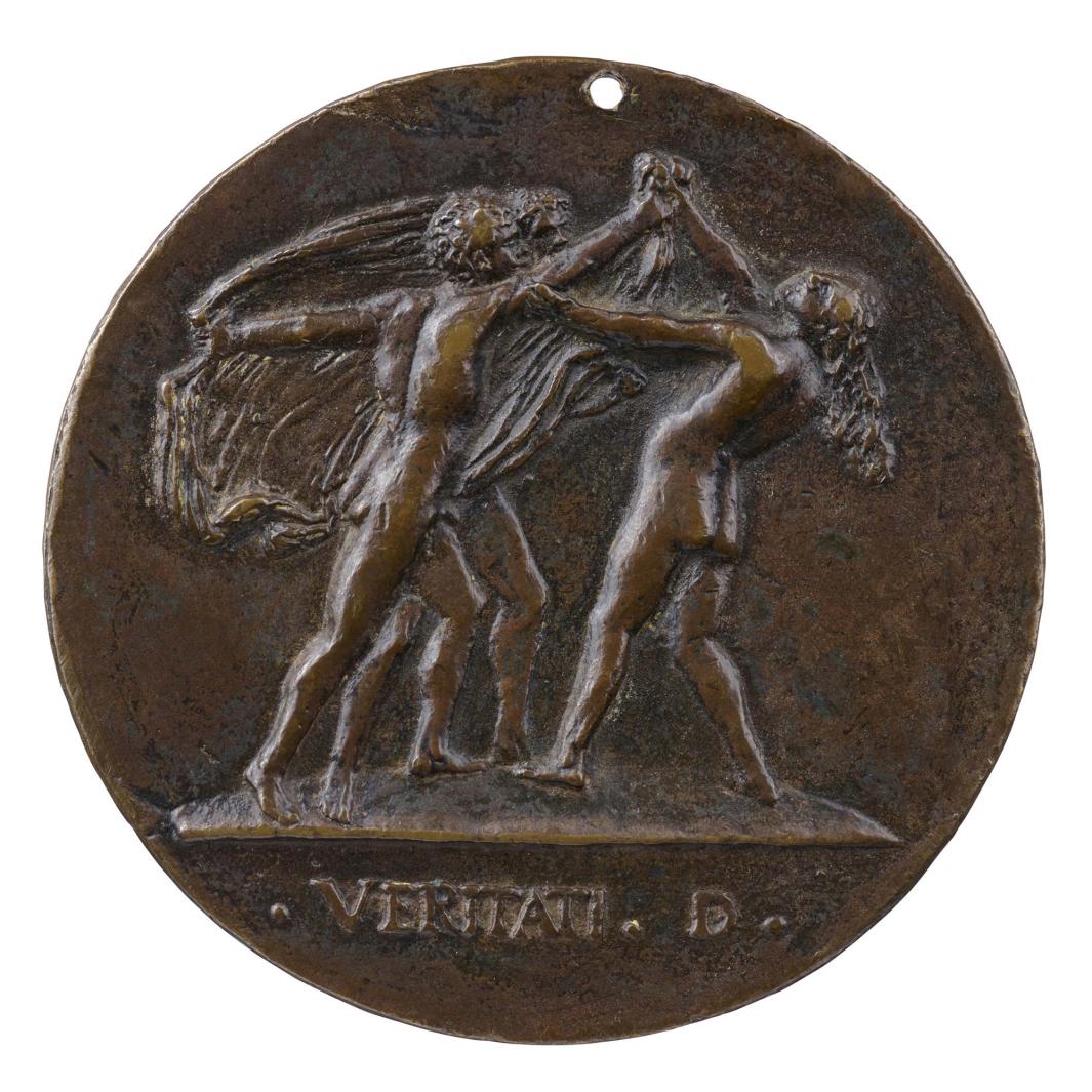 Bronze medal of three nude figures wrestling on a platform